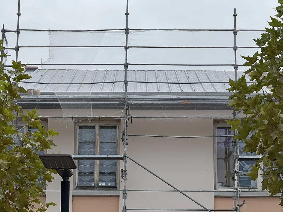 Toiture en rénovation derrière un échafaudage
